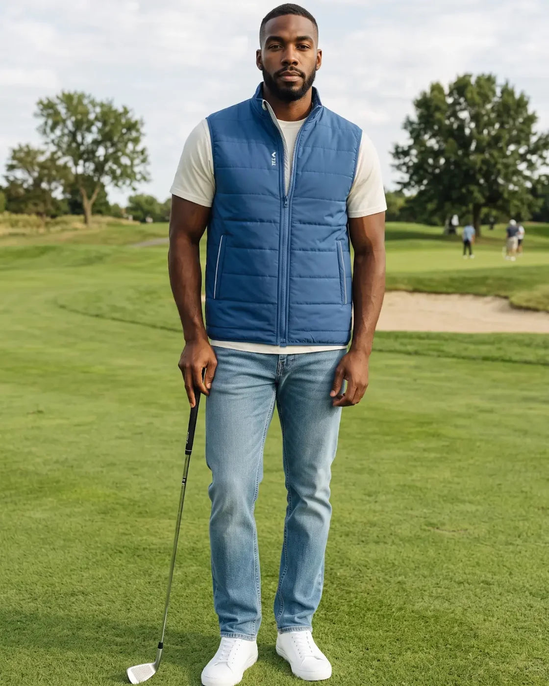 A golfer in the blue TeeUp MagZip Vest on a course