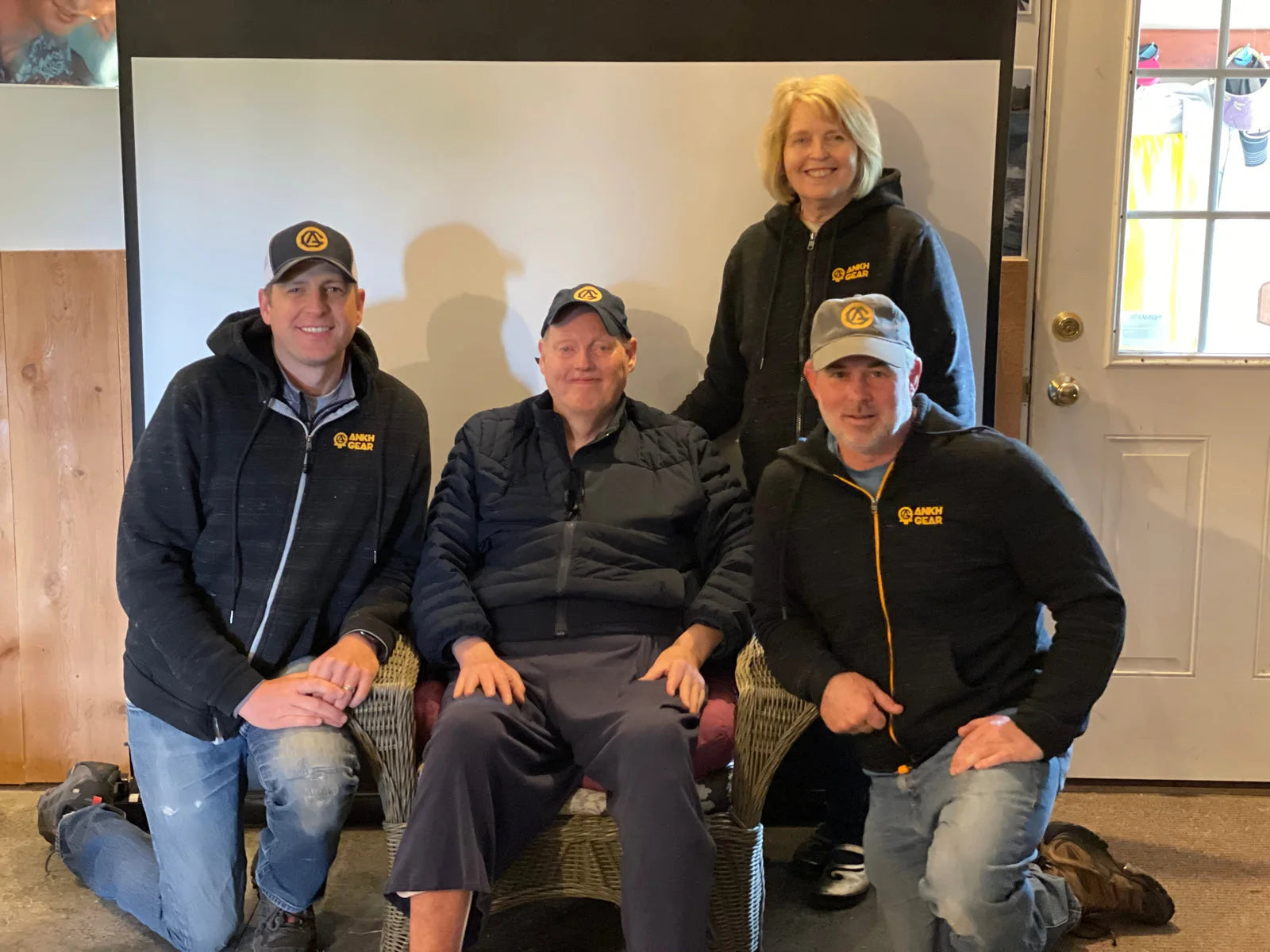 A family group wearing ANKHGEAR hoodies and caps