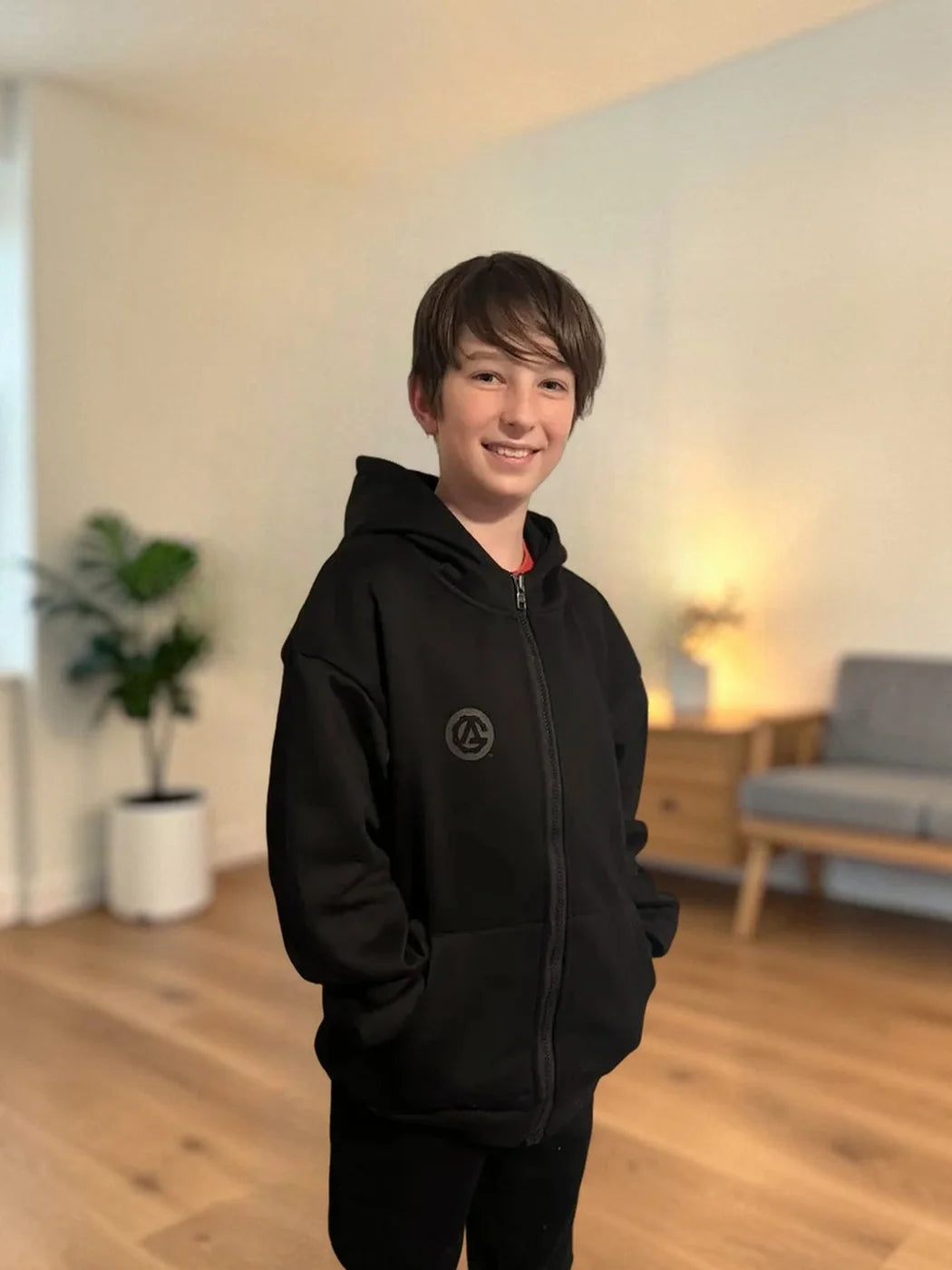 A boy in the black FREEDOM Hoodie and Jogger