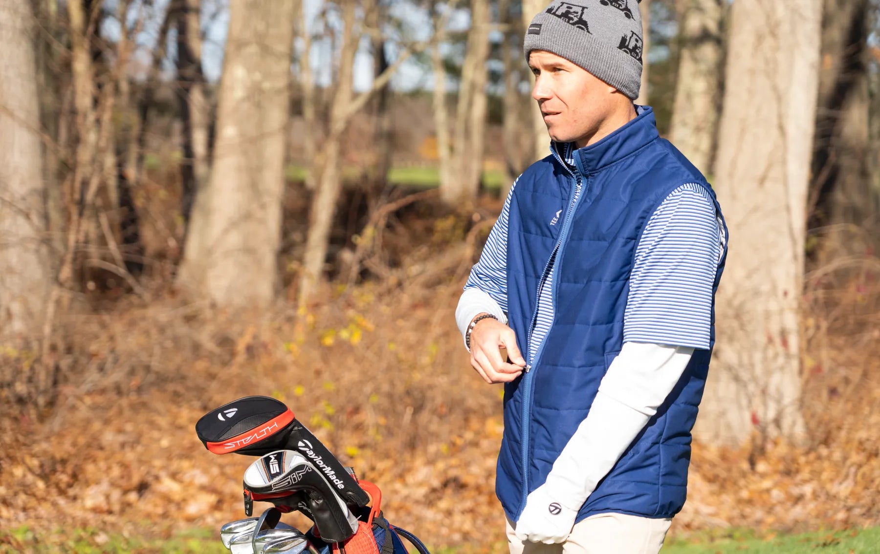 A golfer in a blue TeeUp MagZip Vest on the course