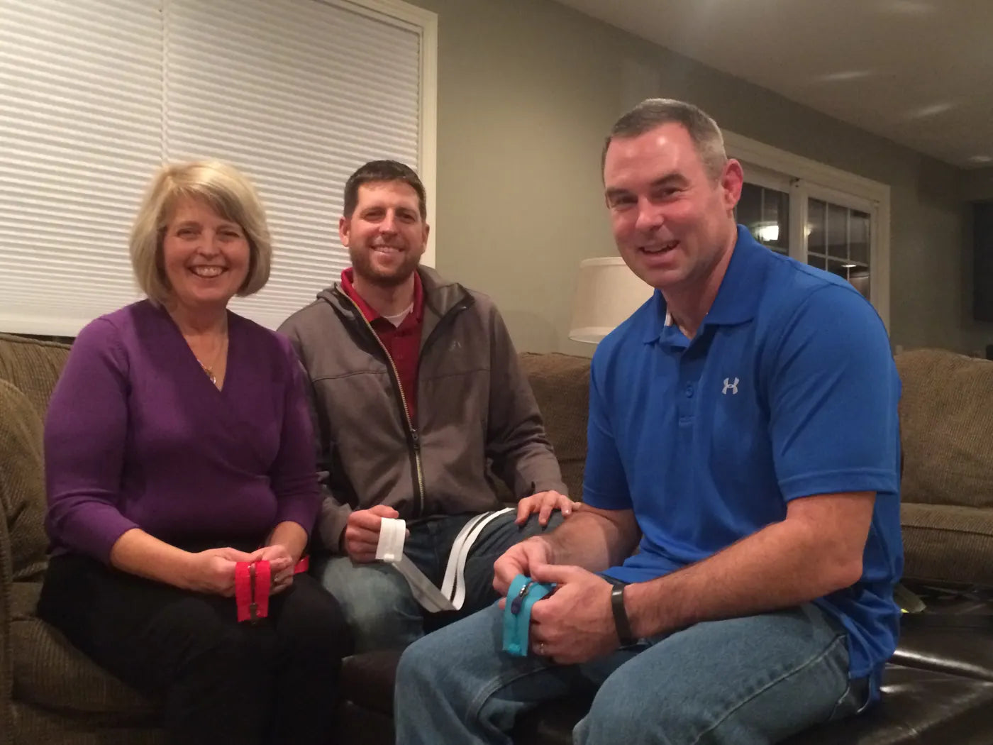 The MagZip team, Nancy, Scott and Dave Lyndaker, on a couch holding MagZip zippers