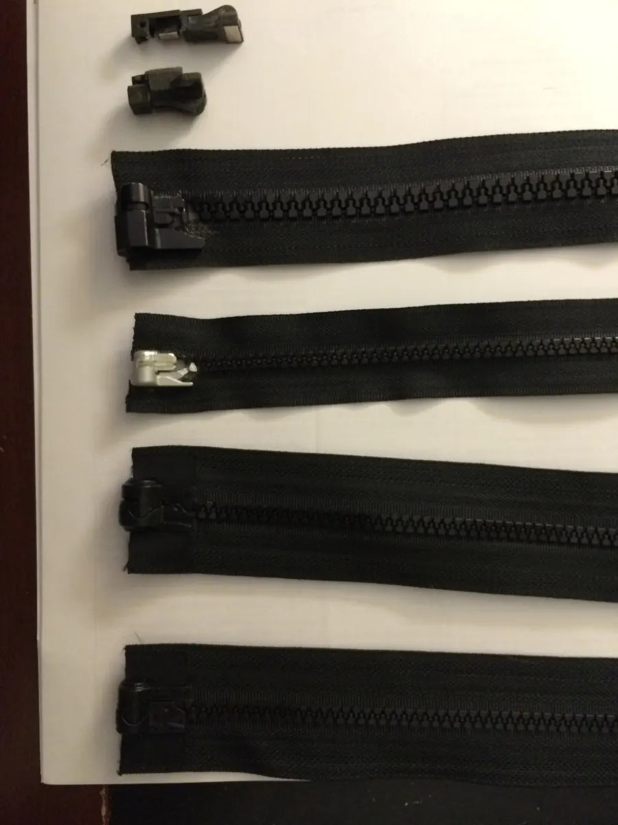 Prototype zippers laid out in order from version 3 to the final design
