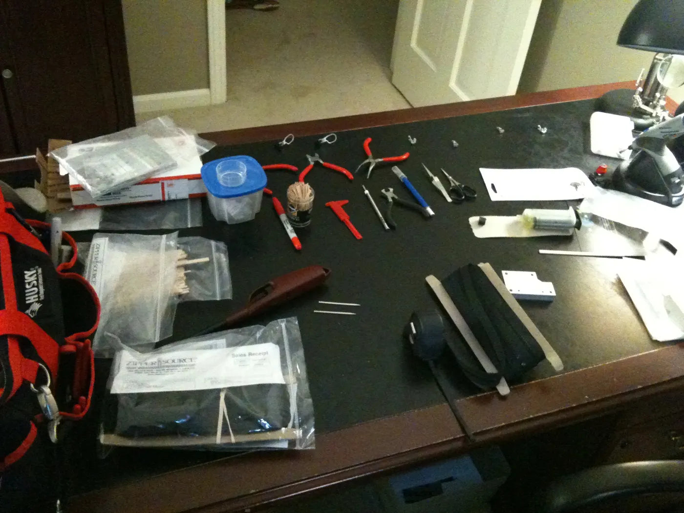 Scott’s desk, the Zipper Lab, covered in pliers, glue, parts and zippers